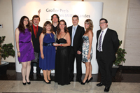 Dr. E. Decker, CEO of Meavision Media (middle, with award) with some team members