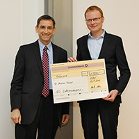 The award, presented by Dr. Ulrich von Hülsen (left), a member of Pfeiffer Vacuum GmbH management.
