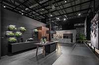Expressive: In front of a black background the premium kitchens are presented in different settings.