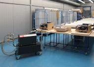 The MINK MV claw vacuum pump as a mobile unit with a vacuum vessel in use on three holding devices 
