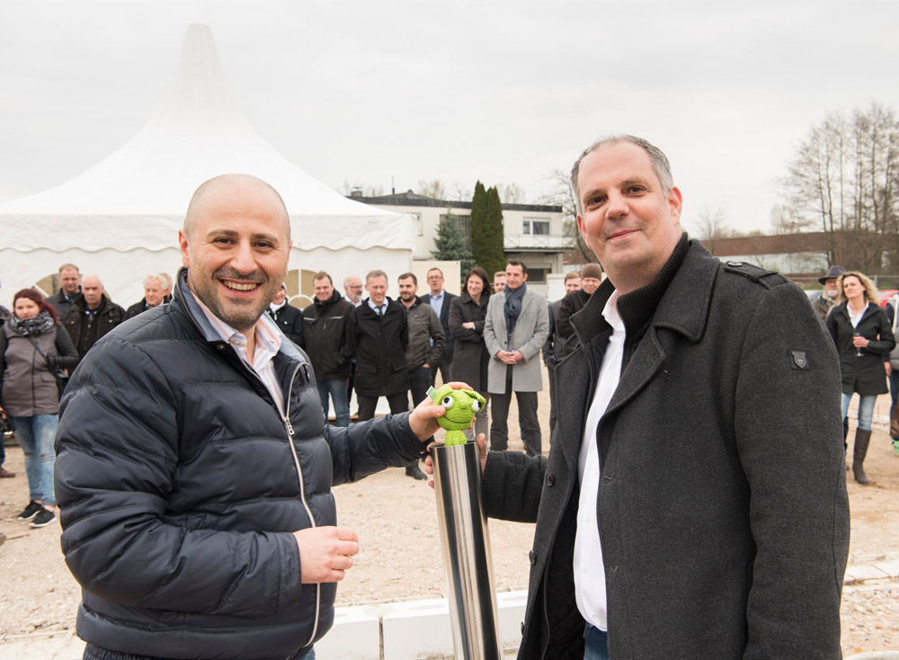 Die primeLine Geschäftsführer Petros Jossifids (links) und Stefan Bangel mit Zeitkapsel und Egino
