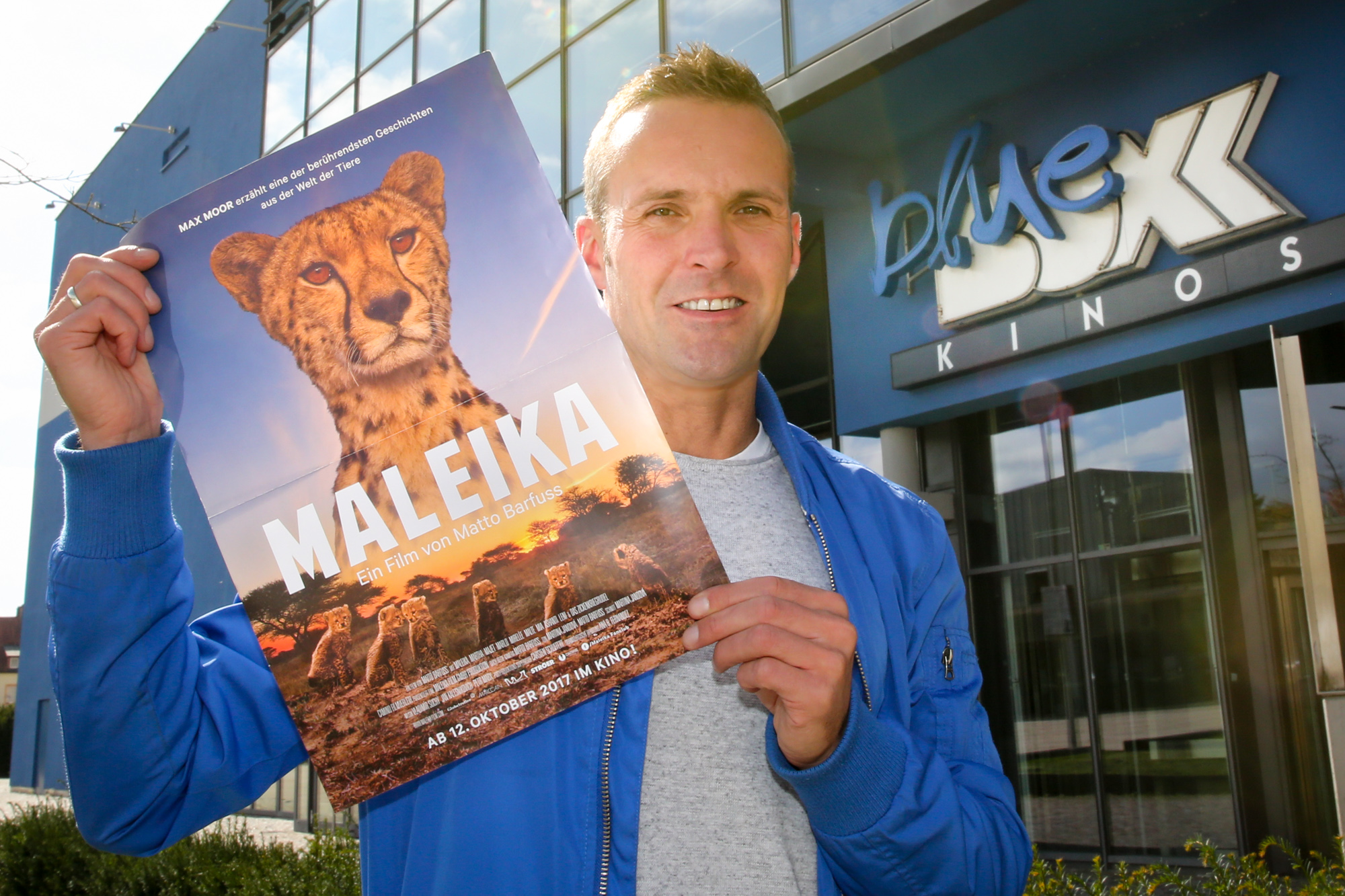 Videoproduzent Martin Kleinert präsentiert stolz das Filmplakat zur Tierdokumentation?Maleika?