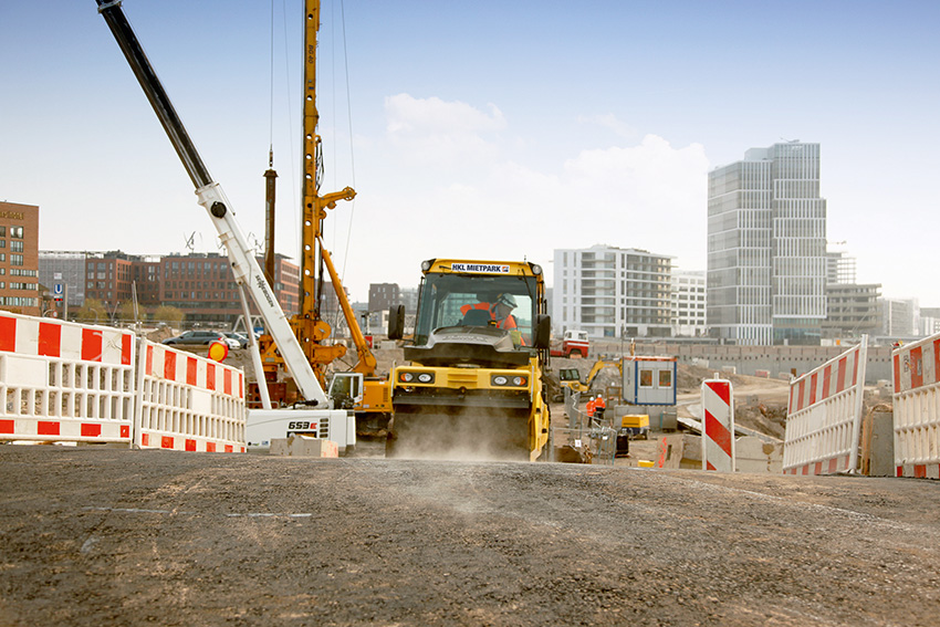Eine Bomag Tandem Asphaltwalze von HKL hilft beim Asphaltieren einer neuen Baustellenzufahrt. Eine Bomag Tandem Asphaltwalze von HKL hilft beim Asphaltieren einer neuen Baustellenzufahrt.