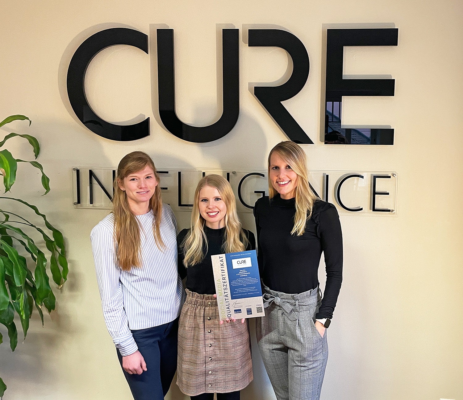 Members of the CURE Intelligence Marketing team receive the Social Media Quality Certificate