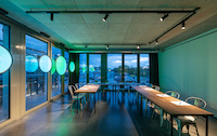 Stromschienen mit Strahlern leuchten die Tische im Konferenzraum aus. (Foto: licht.de/Artemide)