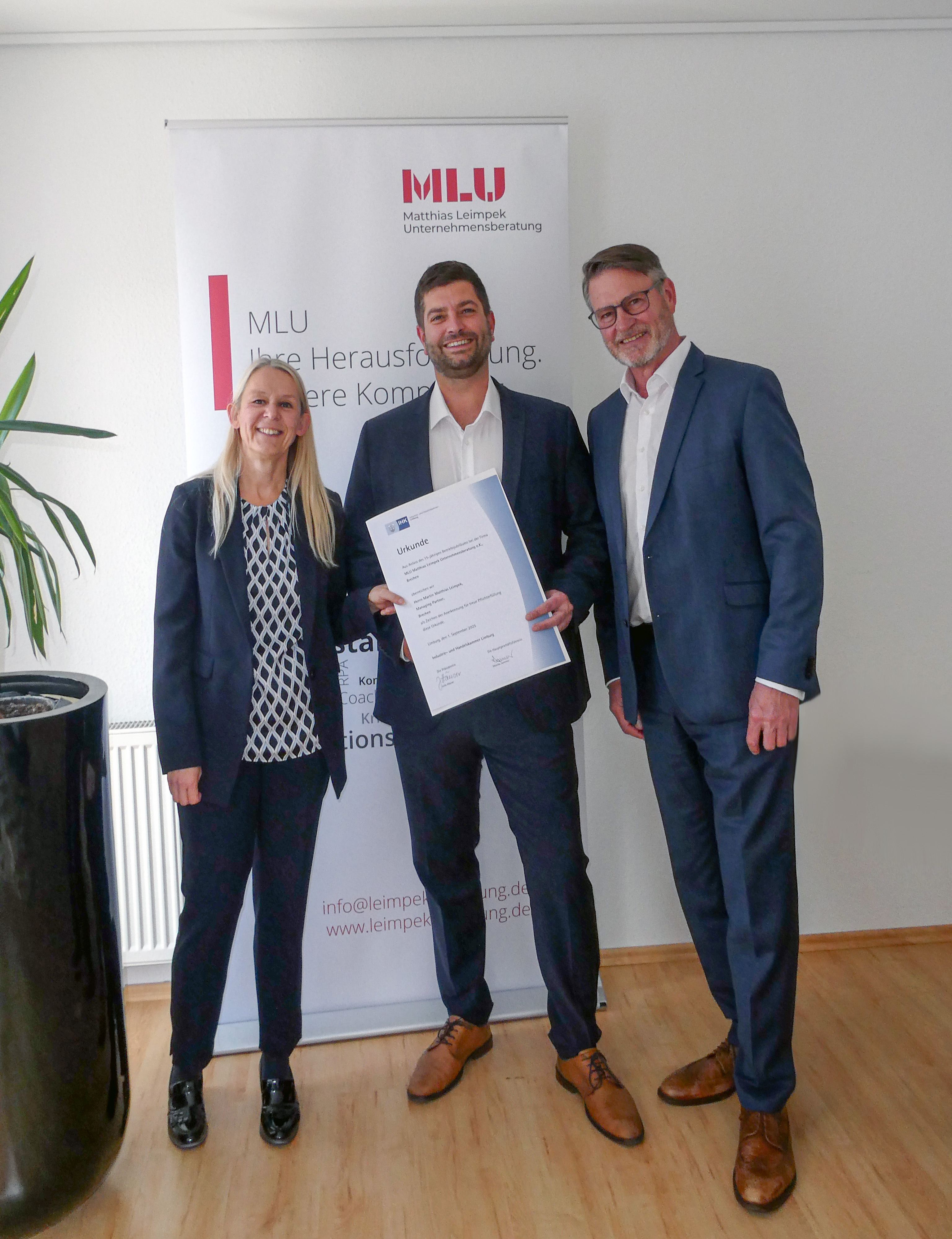 Die Geschäftsführung der MLU überreicht Martin Leimpek die Ehrenurkunde zum 15. Dienstjubiläum.