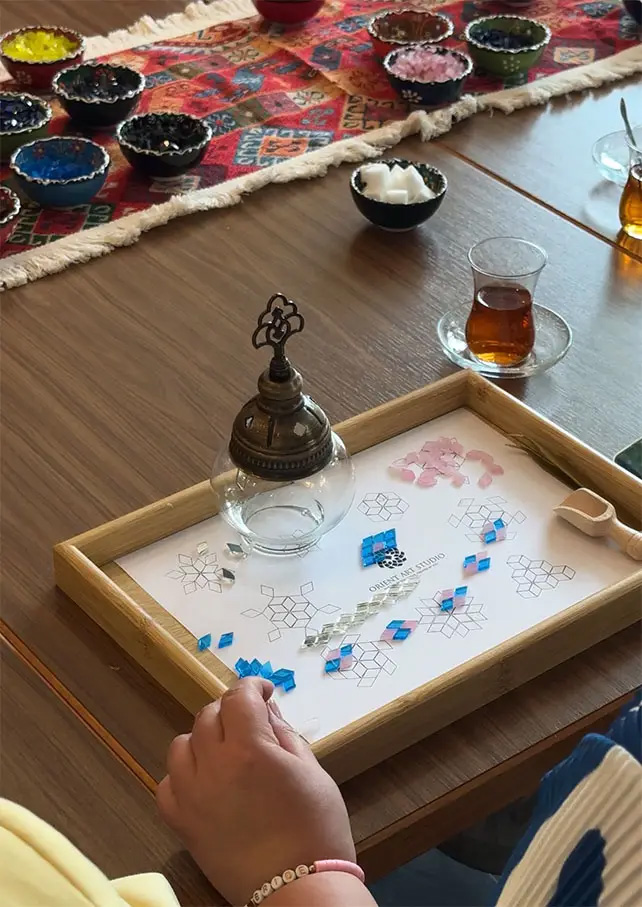 Teilnehmerin gestaltet im Orient Art Studio in Berlin eine orientalische Mosaiklampe in entspannter (Die Bildrechte liegen bei dem Verfasser der Mitteilung.)