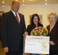 Thomas Packenius übergibt den Spendenscheck an Heike Vongehr (re.). In der Mitte Simone Gilcher
