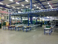 Mehr Fläche durch Stahlbaubühne und Rollenbahnen ermöglichen übersichtliches Kommissionieren