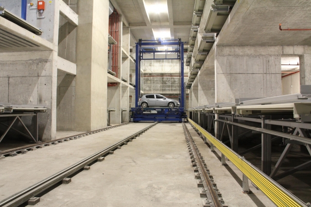 Die Fahrzeuge werden vertikal und horizontal bewegt und in die zugewiesenen Stellplätze befördert. Die Fahrzeuge werden vertikal und horizontal bewegt und in die zugewiesenen Stellplätze befördert.